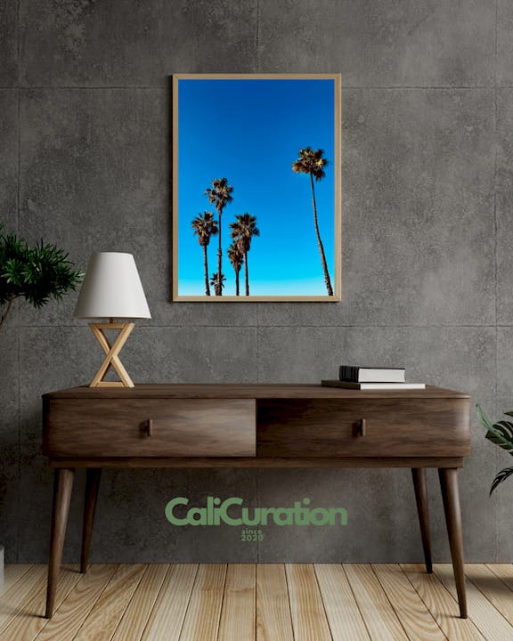 Arranging frames on California-themed gallery wall