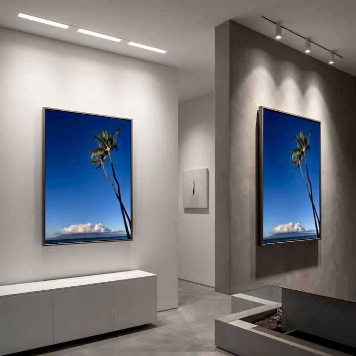 Photographer adjusting wall lighting for art