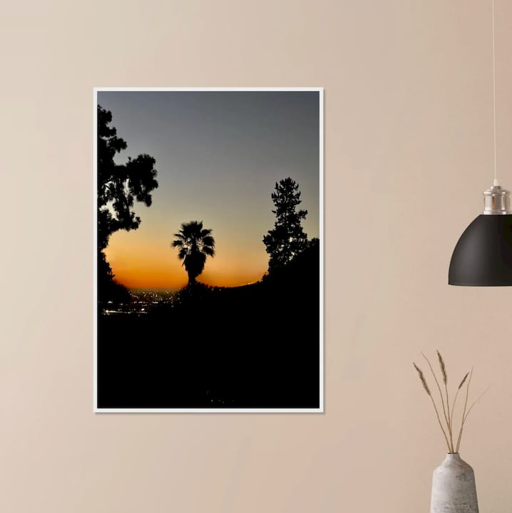 Woman examining elevated wall art in living room