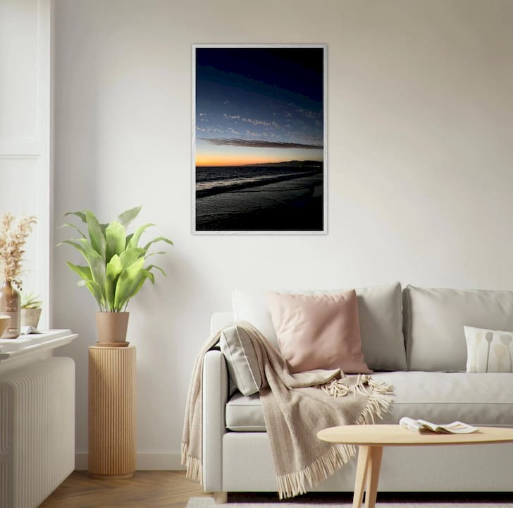Woman examining elevated wall art in living room