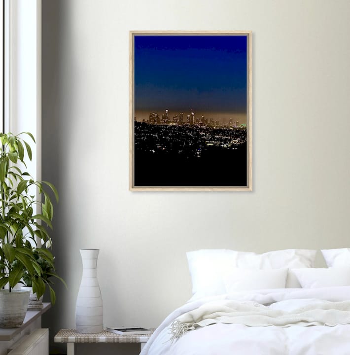 Person hanging photographic wall art in modern living room