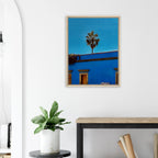 Colorful canvas print of Oaxaca streets with palm trees, framed in blue from CaliCuration's travel collection.
