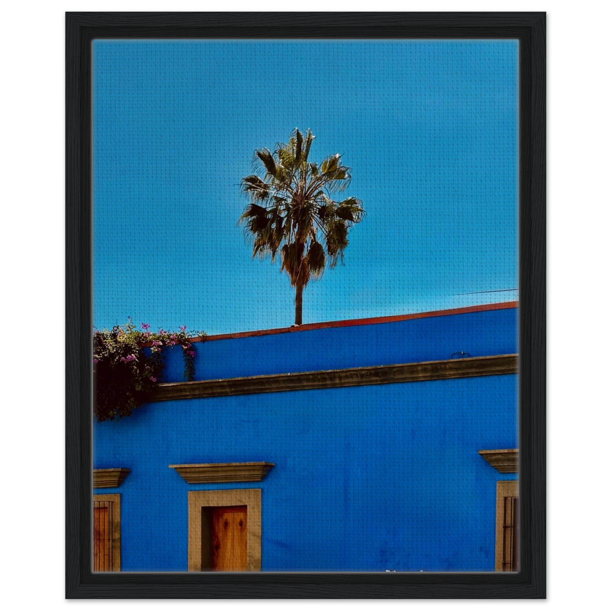 Oaxaca streets scene print by CaliCuration showing palm trees and colorful buildings in a blue framed canvas artwork.