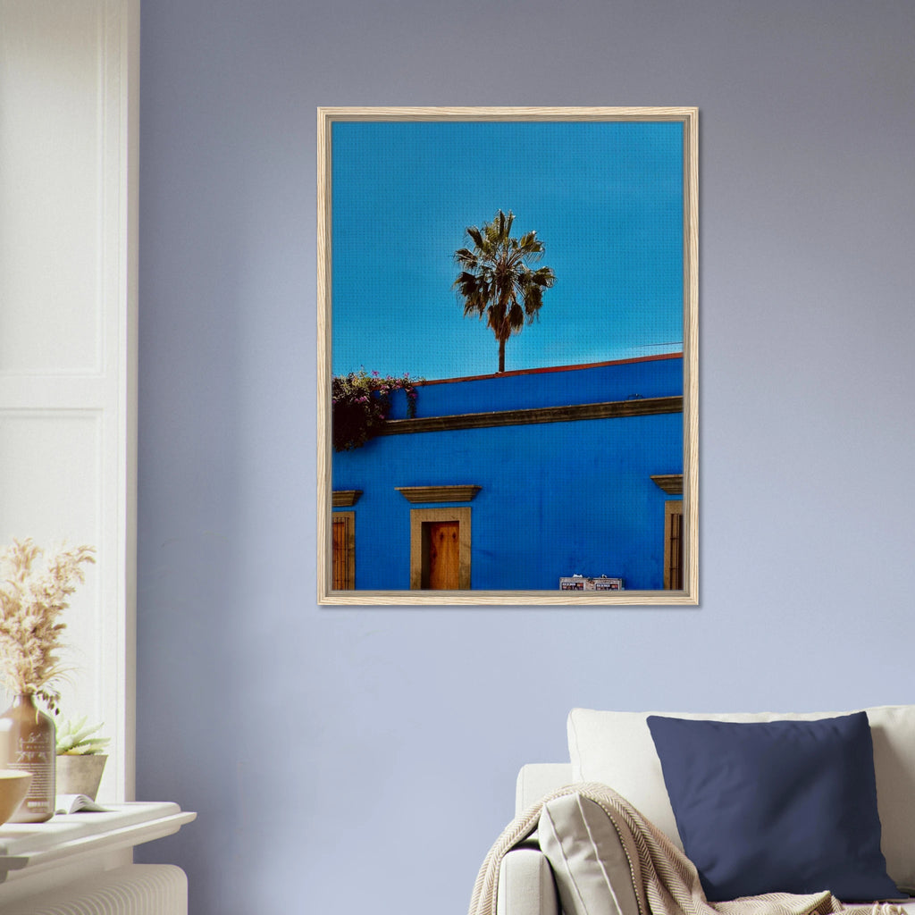 Oaxaca streets scene print by CaliCuration, featuring palm trees and vibrant colors in a blue framed canvas artwork.