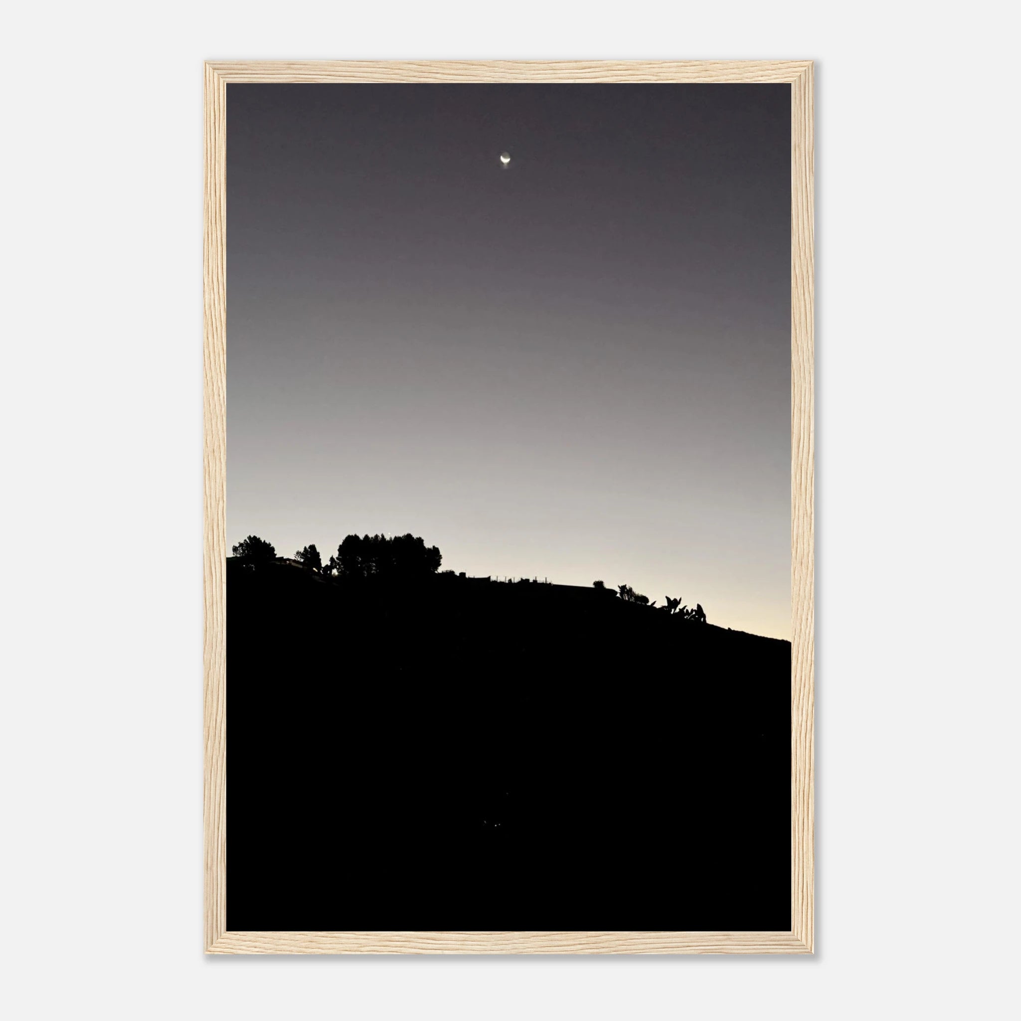 Black and white wooden framed poster of the Fall New Moon over Hollywood Hills, California art print in semi-glossy finish.