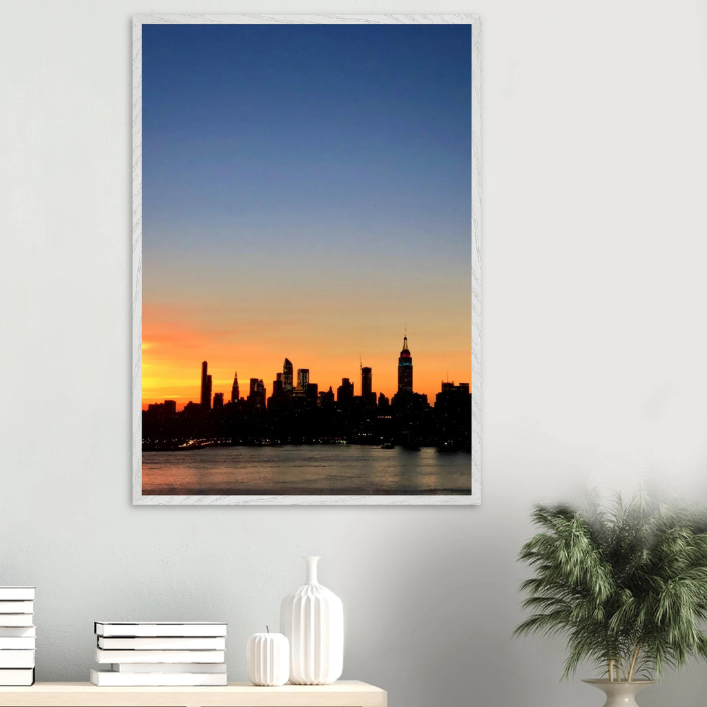 Premium wooden framed Manhattan Skyline sunset poster, travel-themed wall art with vibrant colors and a sleek studio edition design.