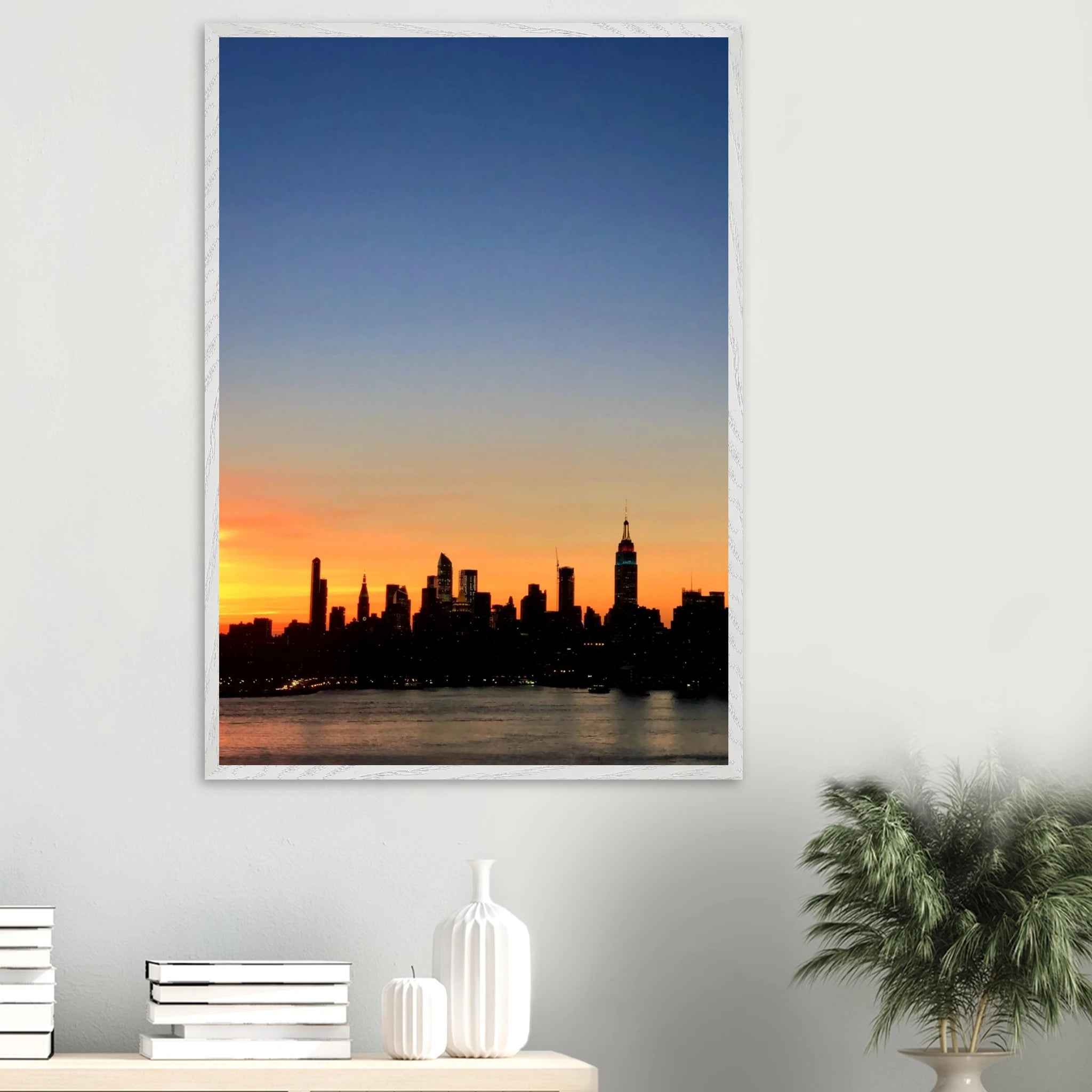 Premium wooden framed Manhattan Skyline sunset poster, travel-themed wall art with vibrant colors and a sleek studio edition design.