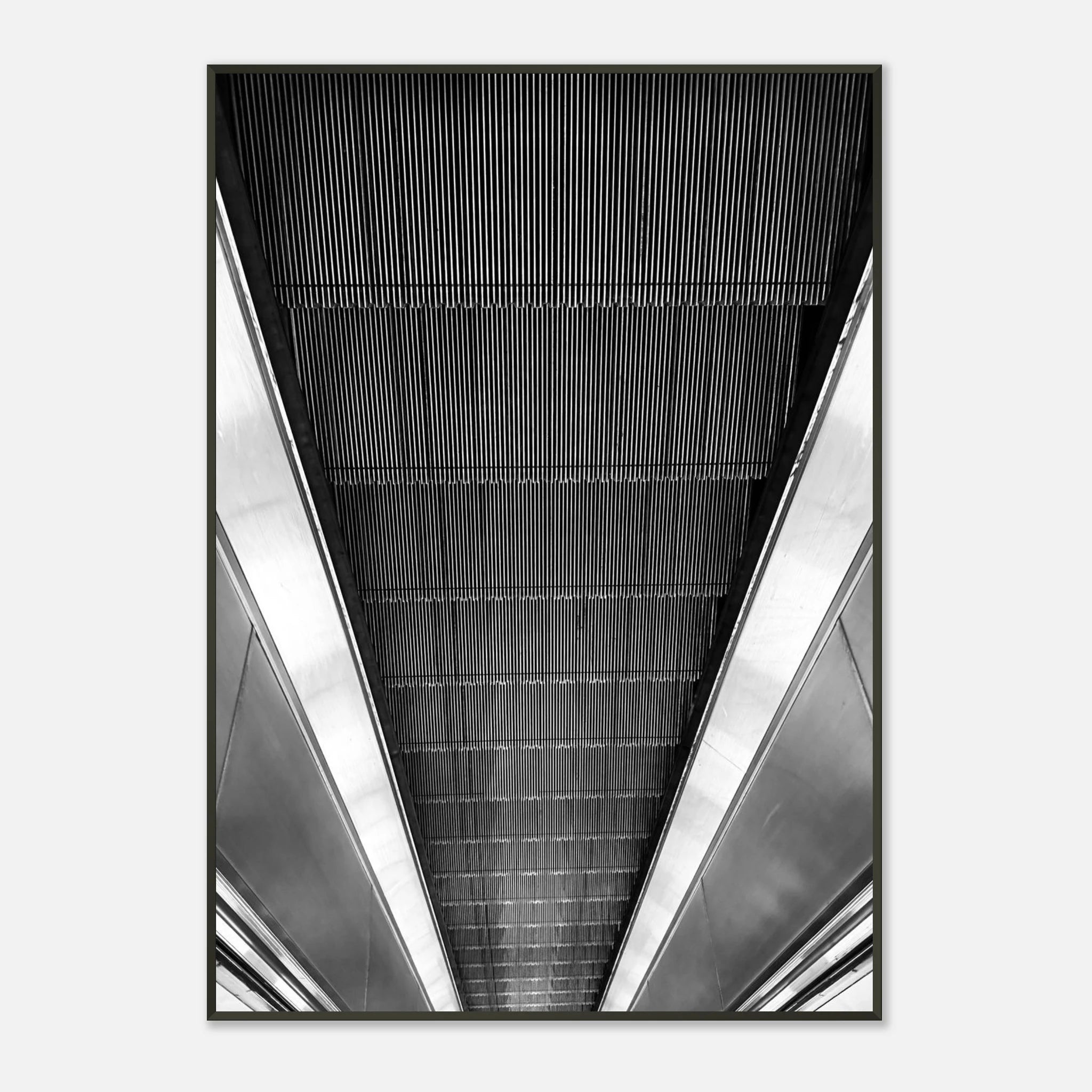 Black and white framed poster of London's tube escalator, part of the Studio Edition travel collection, displayed as a print.
