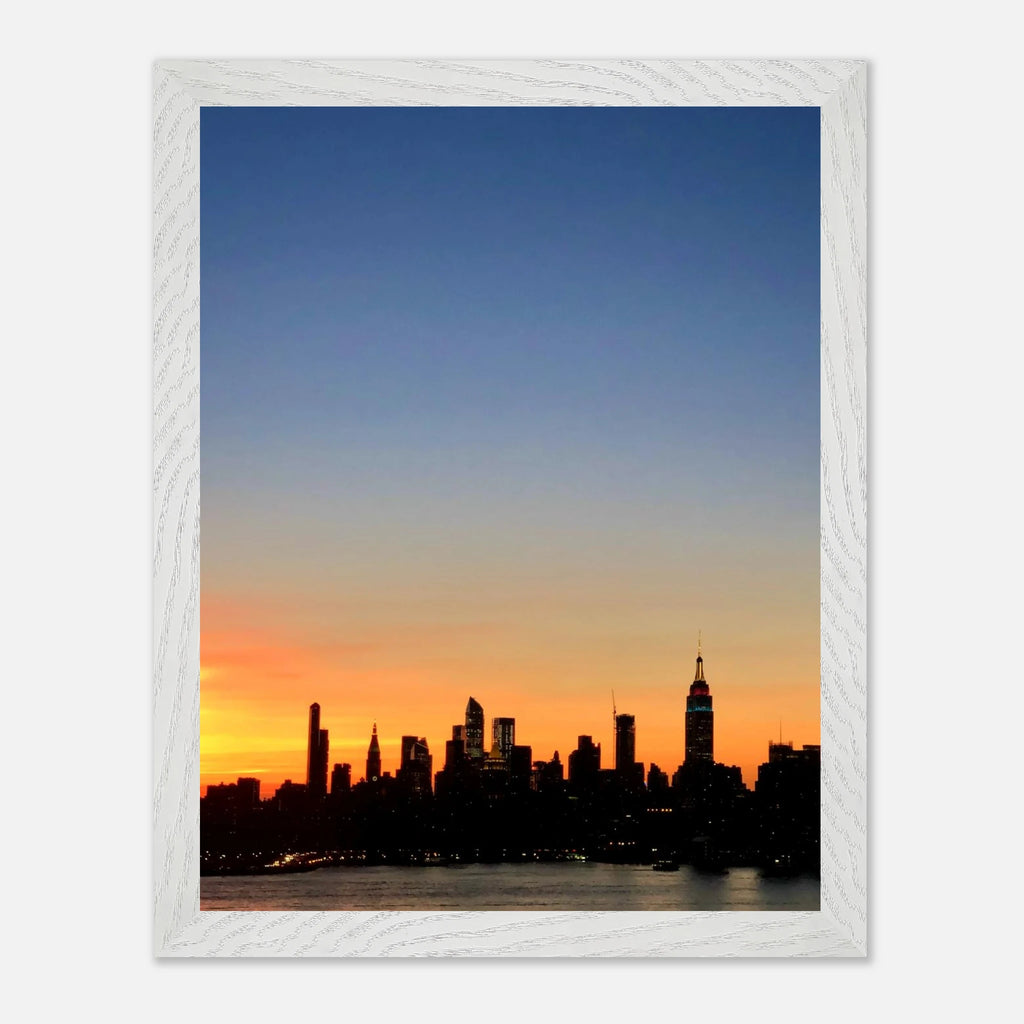 Wooden framed print of the Manhattan skyline at sunset, featuring vibrant colors and detailed cityscape in a travel-themed wall art piece.