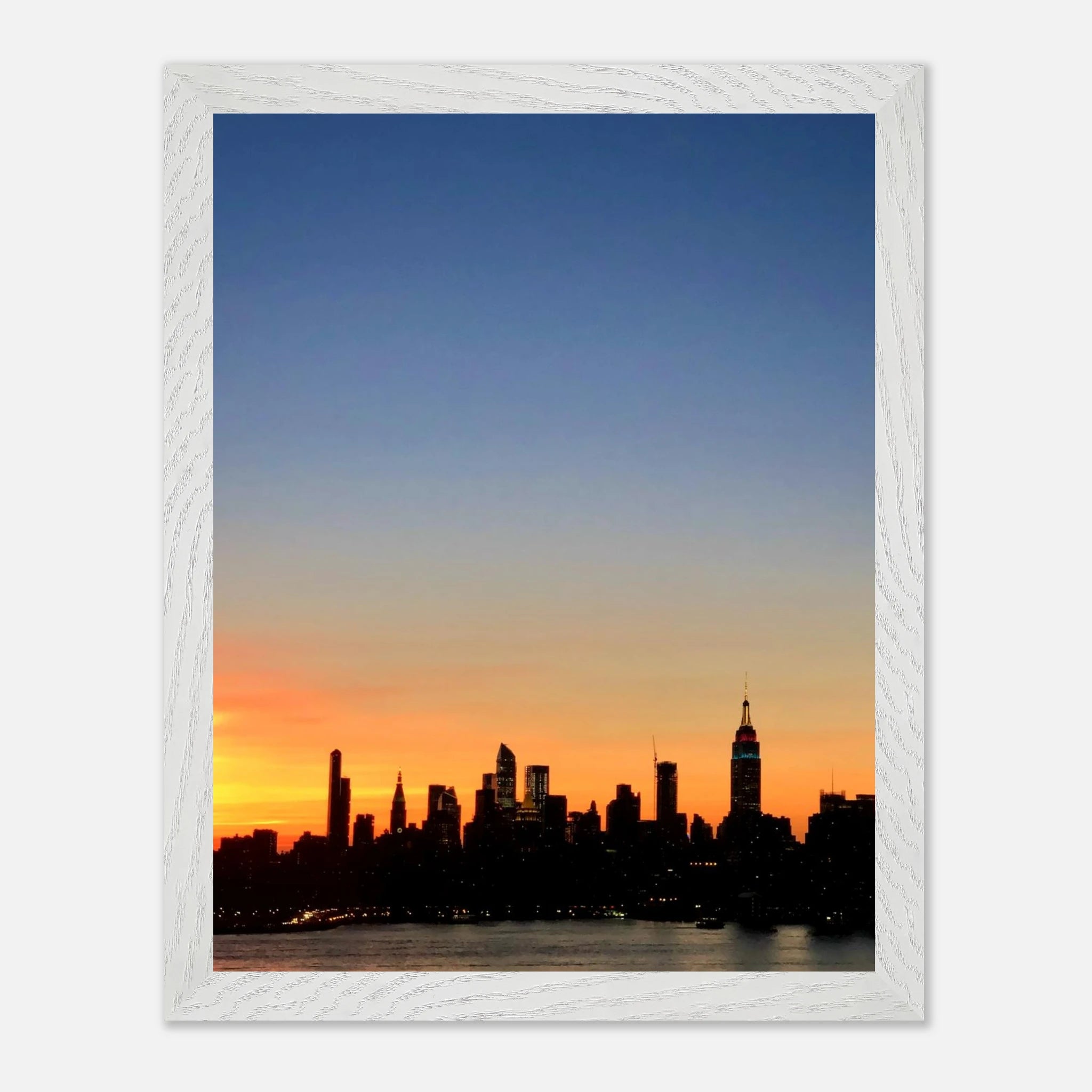 Wooden framed print of the Manhattan skyline at sunset, featuring vibrant colors and detailed cityscape in a travel-themed wall art piece.