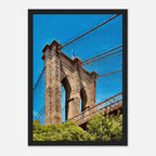 Framed NYC Brooklyn Bridge poster featuring Dumbo view, showcasing iconic New York City skyline in vibrant print material.