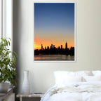 Manhattan Skyline sunset framed poster, NYC wall art print on high-quality material, featuring vibrant cityscape colors.