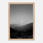Black and white framed poster of California Central Coast sunset from the Studio Edition travel collection, mounted on a wall.