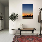 Manhattan Skyline sunset framed poster featuring NYC cityscape wall art in print material, showcasing vibrant sunset colors over the skyline.