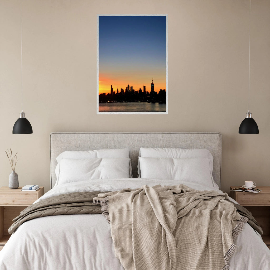 Premium wooden framed poster of the Manhattan skyline at sunset, featuring travel-themed wall art with a Studio Edition print.