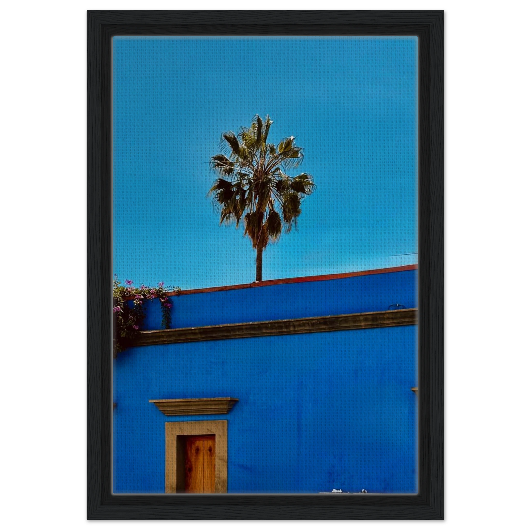 Colorful print of Oaxaca streets with palm trees on blue framed canvas artwork by CaliCuration from the Mexico travel collection.