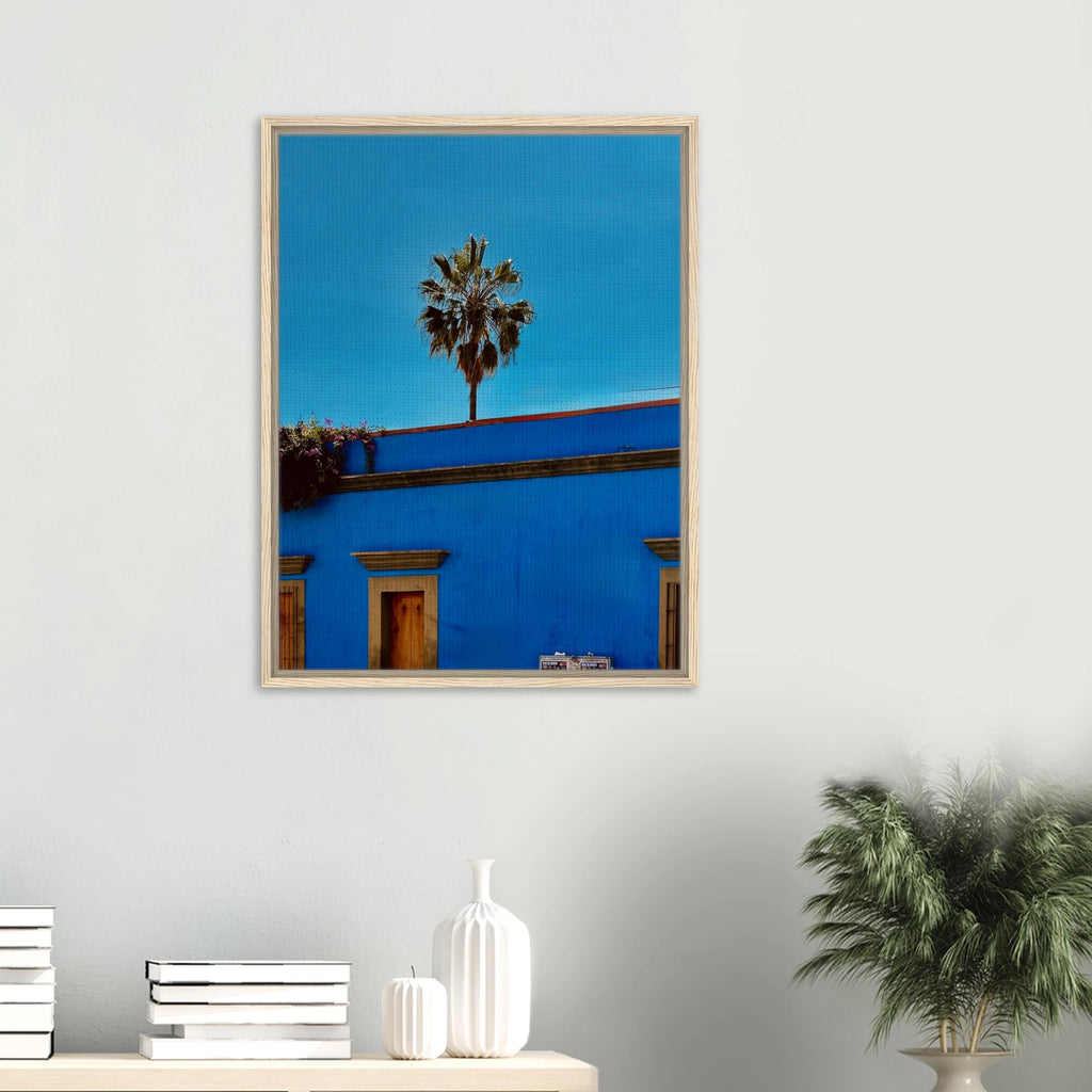 Colorful print of Oaxaca streets with palm trees on blue framed canvas artwork by CaliCuration from the Mexico travel collection.