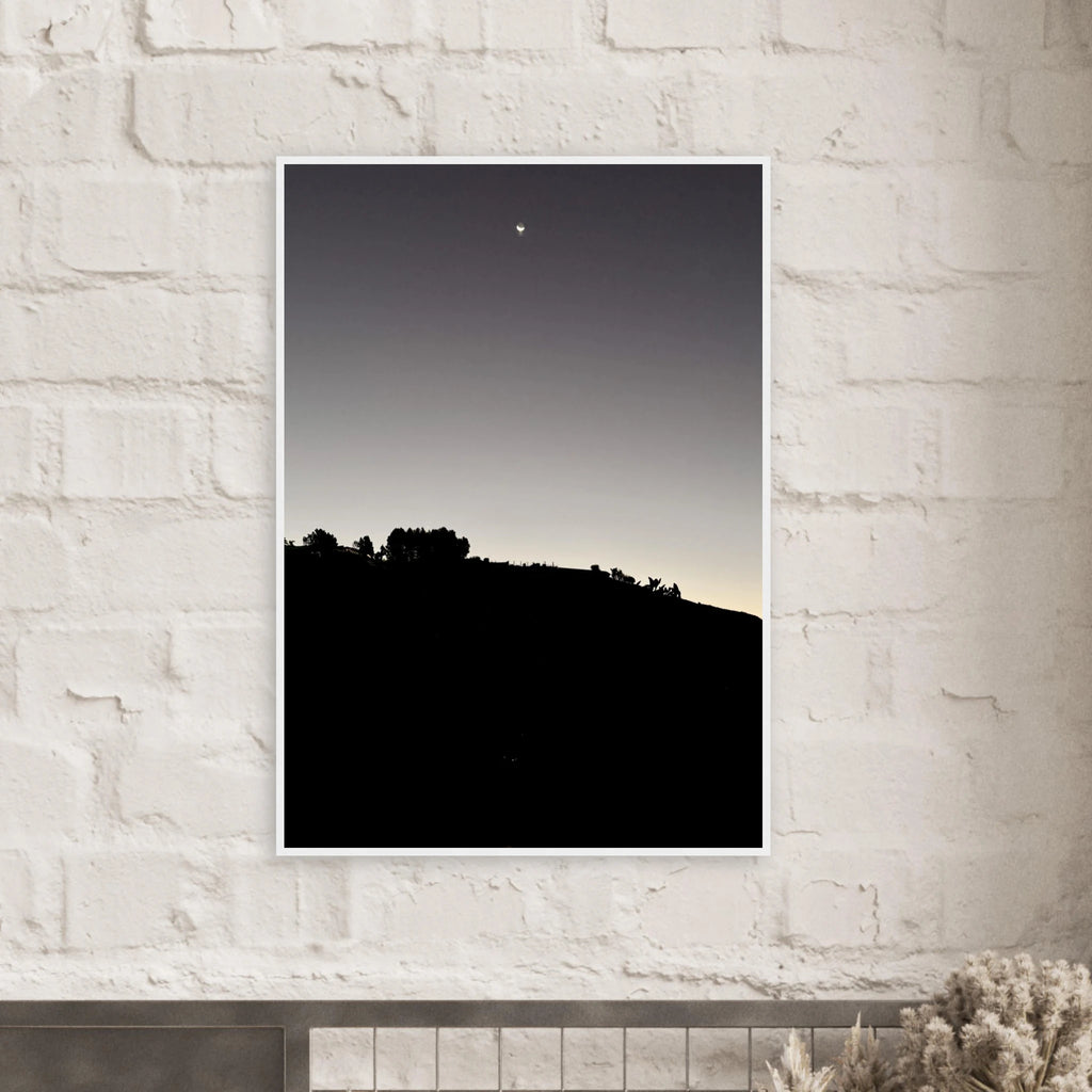 Black and white semi-glossy poster print featuring a fall new moon over Hollywood Hills in California, framed with wood.