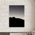 Black and white semi-glossy poster print featuring a fall new moon over Hollywood Hills in California, framed with wood.