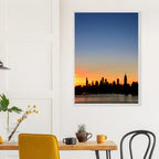 NYC Manhattan skyline sunset framed poster wall art on print material, showcasing New York City at dusk with vibrant cityscape details.