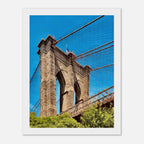 Framed NYC Brooklyn Bridge poster featuring a Dumbo view, showcasing vibrant cityscape print from the Studio Edition travel collection.