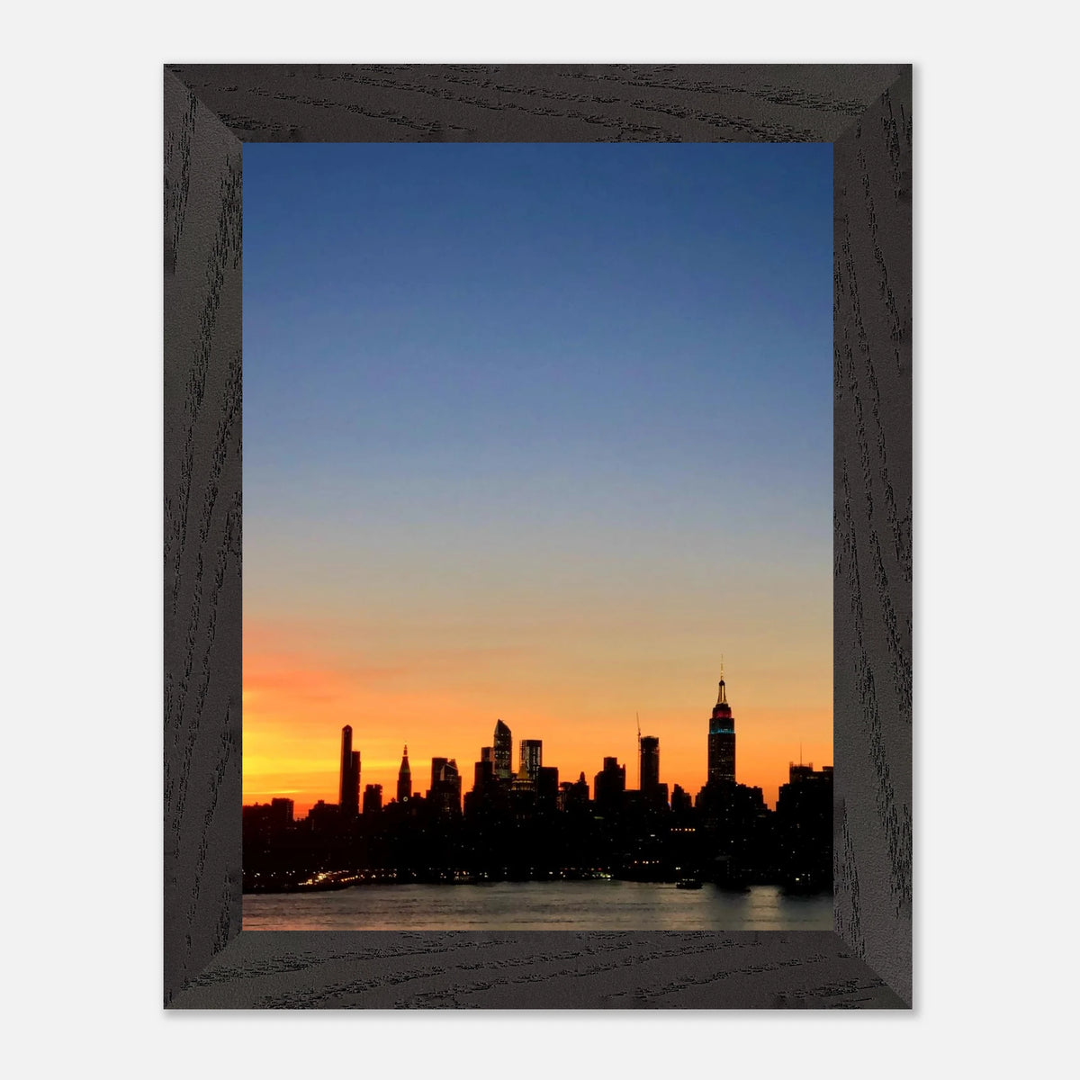 Framed Manhattan skyline sunset print featuring NYC cityscape, vibrant colors, and modern wall art design.