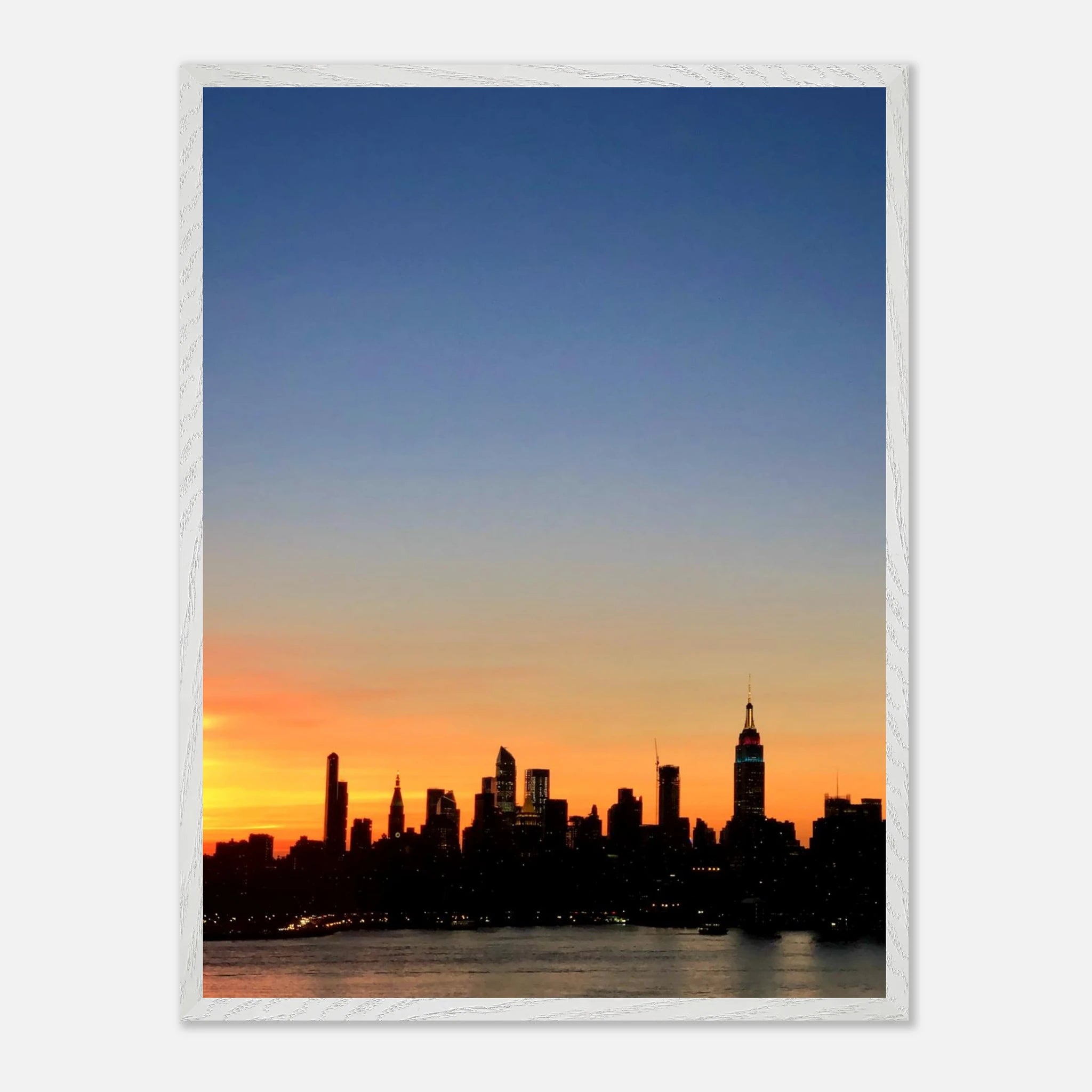 Wooden framed Manhattan Skyline sunset poster from the Travel Collection, featuring a vibrant cityscape wall art print.