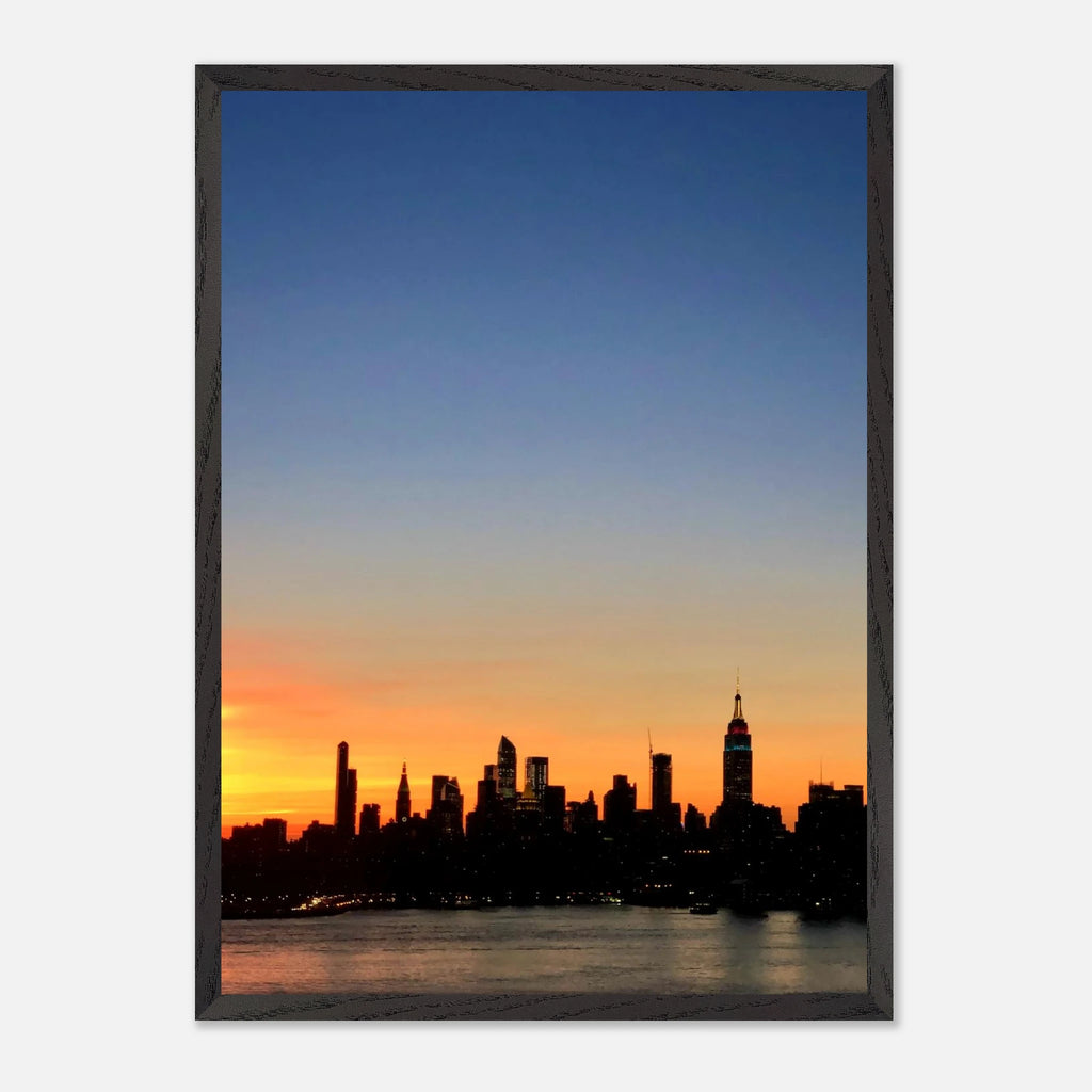 Wooden framed poster of Manhattan skyline at sunset, featuring vibrant cityscape and warm colors, ideal for home wall decor.