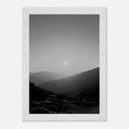 Black and white framed poster of California Central Coast sunset from the Studio Edition print collection displayed on a wall.