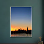 Premium wooden framed poster of Manhattan skyline at sunset, featuring vibrant cityscape wall art from the Studio Edition travel collection.