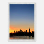 Wooden framed print of the Manhattan skyline at sunset, showcasing vibrant colors and detailed cityscape wall art for home décor.