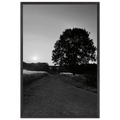Black and white framed poster of Cotswolds summer landscape, English countryside wall art on print material with wooden frame.