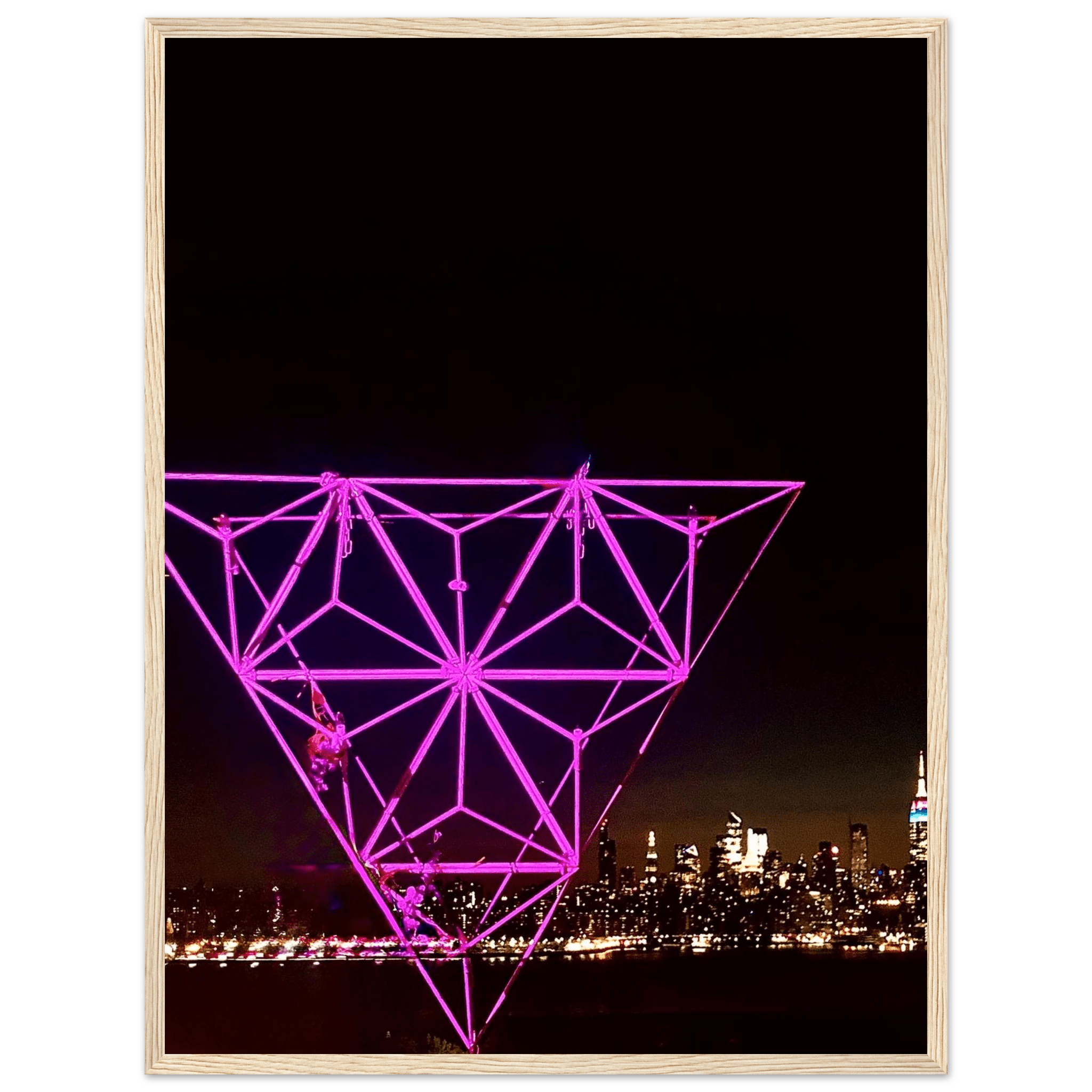 Framed print of a New York City night view with Empire State Building, featuring purple holiday-themed artwork in a Manhattan skyline scene.