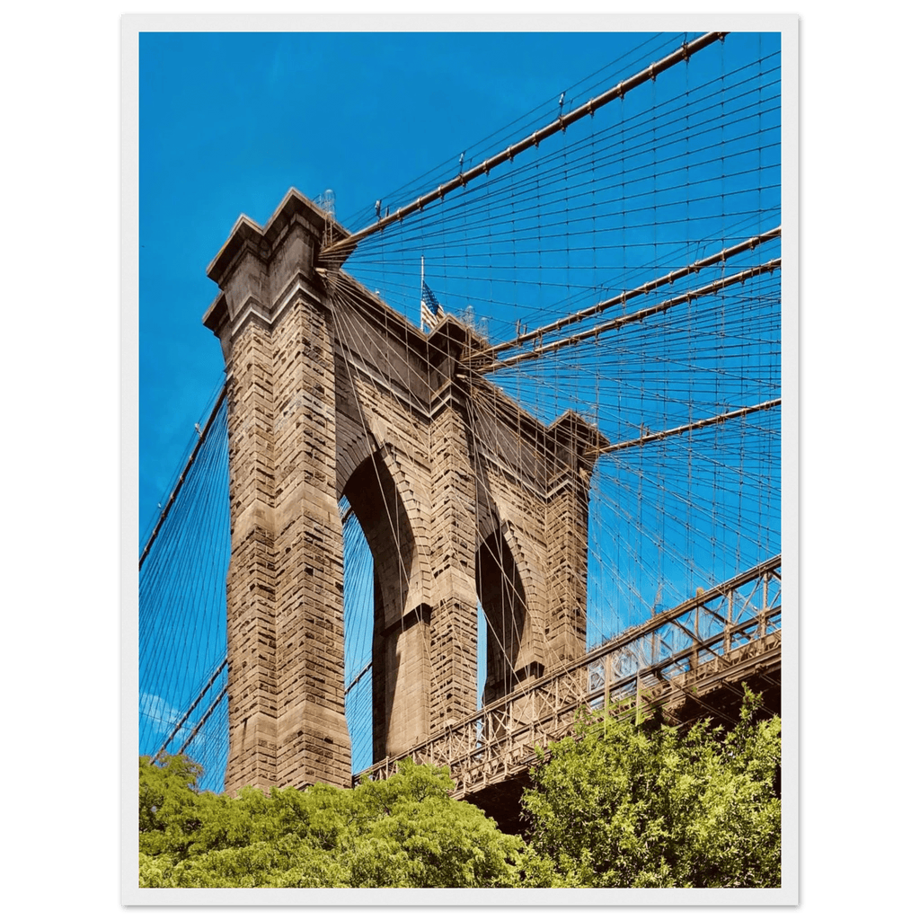 Framed NYC Brooklyn Bridge poster featuring Dumbo skyline view in white frame, part of travel collection print, studio edition.
