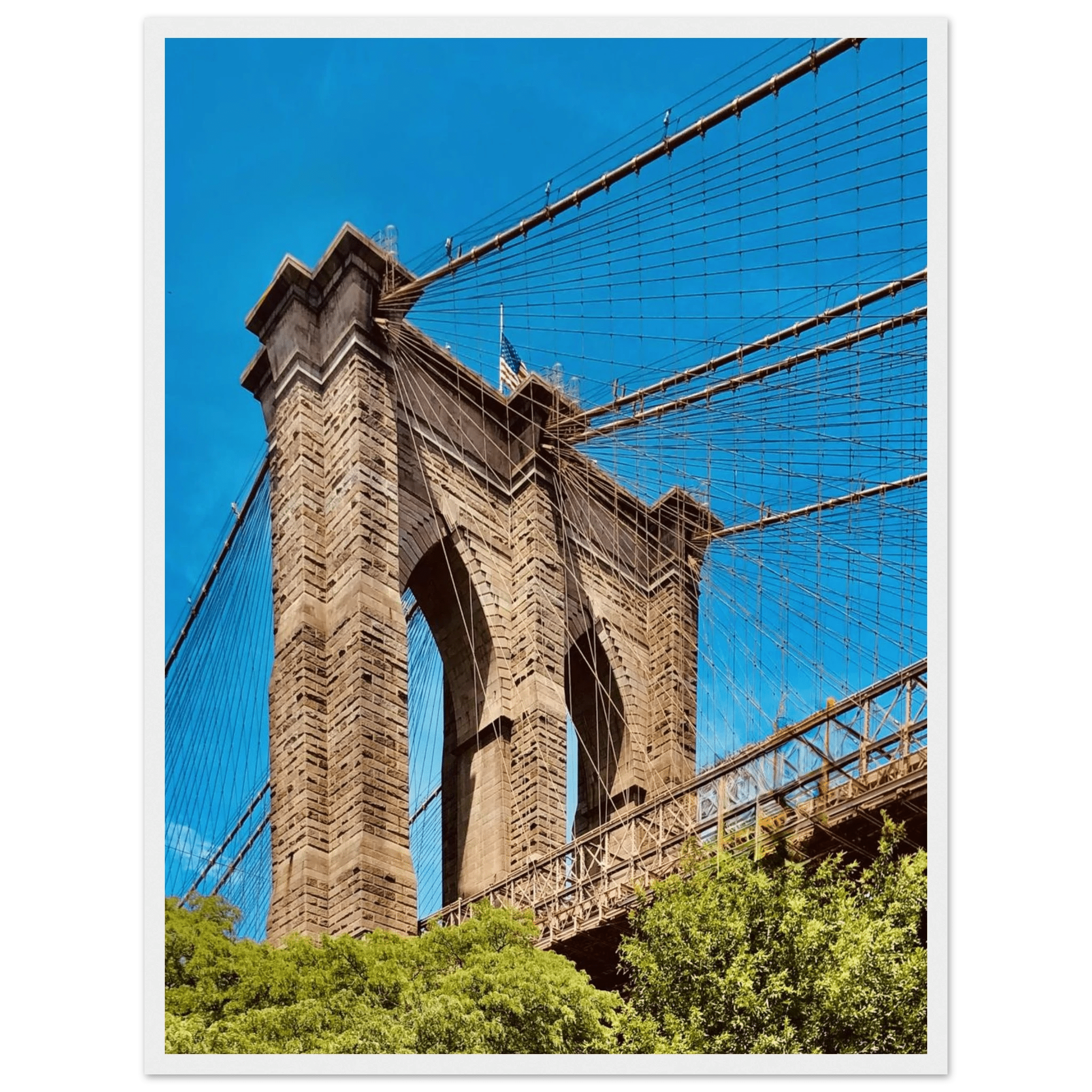 Framed NYC Brooklyn Bridge poster featuring Dumbo skyline view in white frame, part of travel collection print, studio edition.