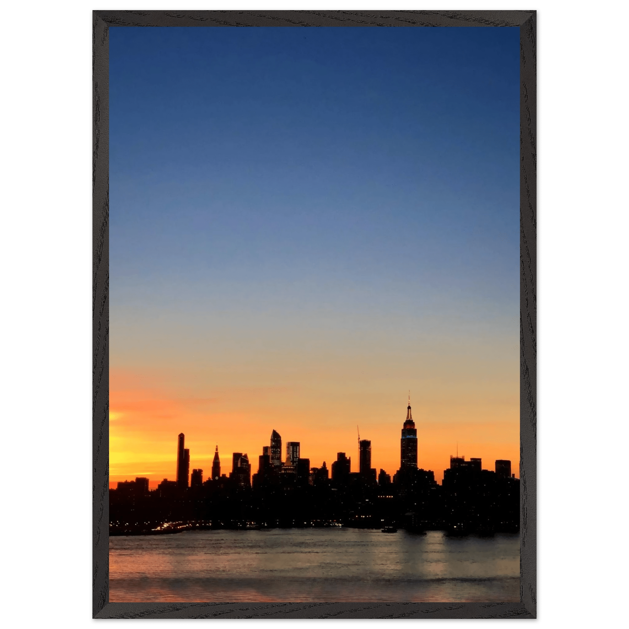 Wooden framed Manhattan skyline sunset poster from the Travel Collection, featuring a vibrant cityscape wall art for home décor.