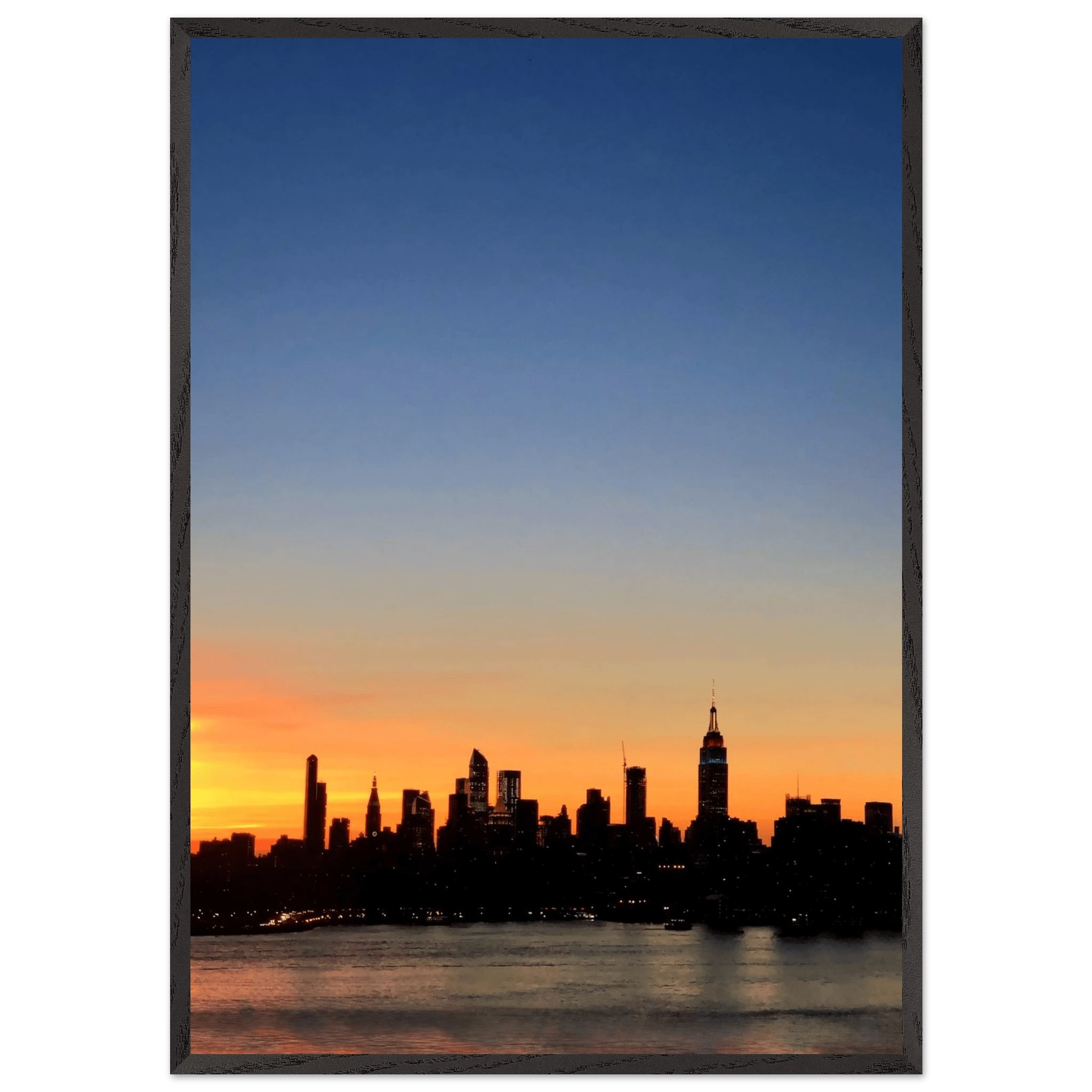 Wooden framed Manhattan skyline sunset poster, majestic cityscape wall art for home décor, part of travel collection studio edition.