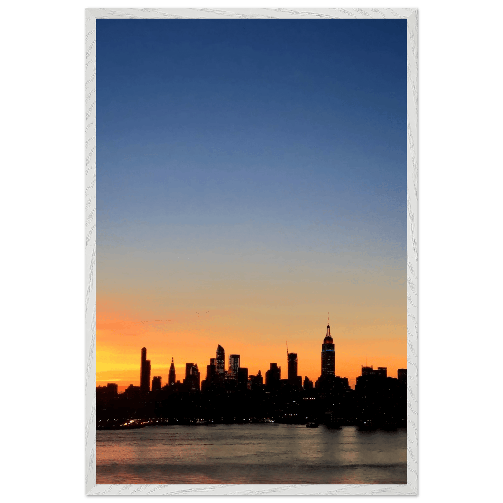 Wooden framed poster of the Manhattan skyline at sunset, featuring vibrant colors and majestic cityscape wall art for home décor.