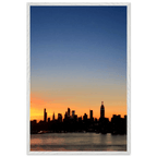 Wooden framed poster of the Manhattan skyline at sunset, featuring vibrant colors and majestic cityscape wall art for home décor.