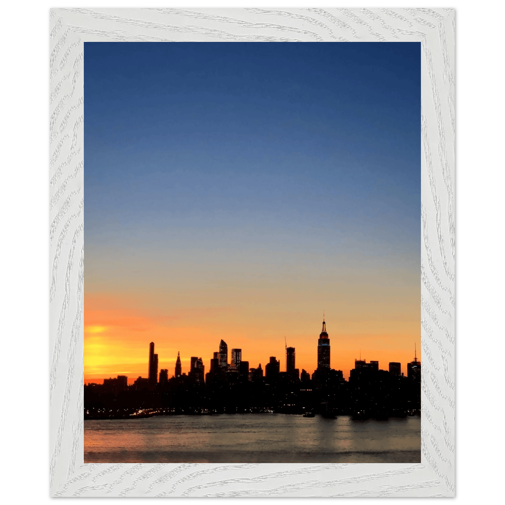 Wooden framed poster of the Manhattan skyline at sunset, featuring vibrant colors and detailed cityscape wall art for home decor.