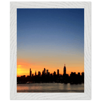 Wooden framed poster of the Manhattan skyline at sunset, featuring vibrant colors and detailed cityscape wall art for home decor.
