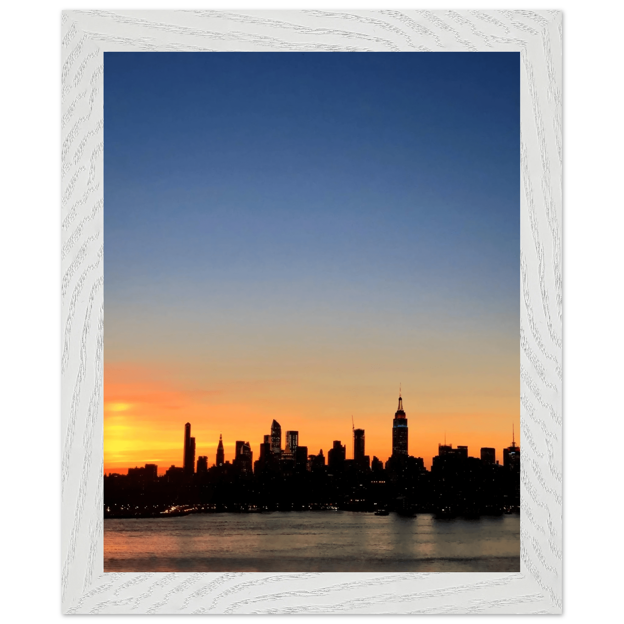 Wooden framed poster of the Manhattan skyline at sunset, featuring vibrant colors and detailed cityscape wall art for home decor.