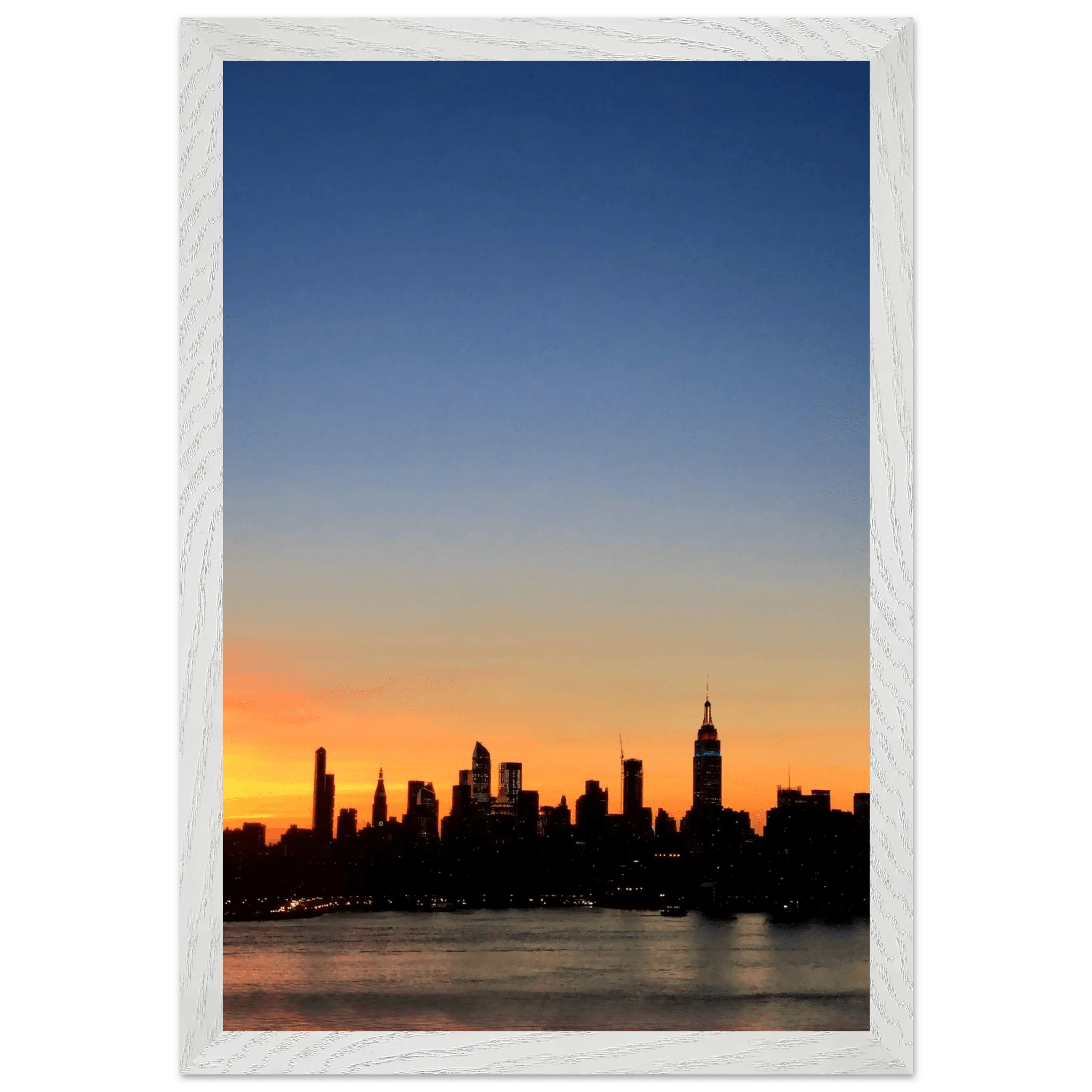 Wooden framed poster of Manhattan skyline at sunset, featuring vibrant colors, ideal for home decor and wall art.