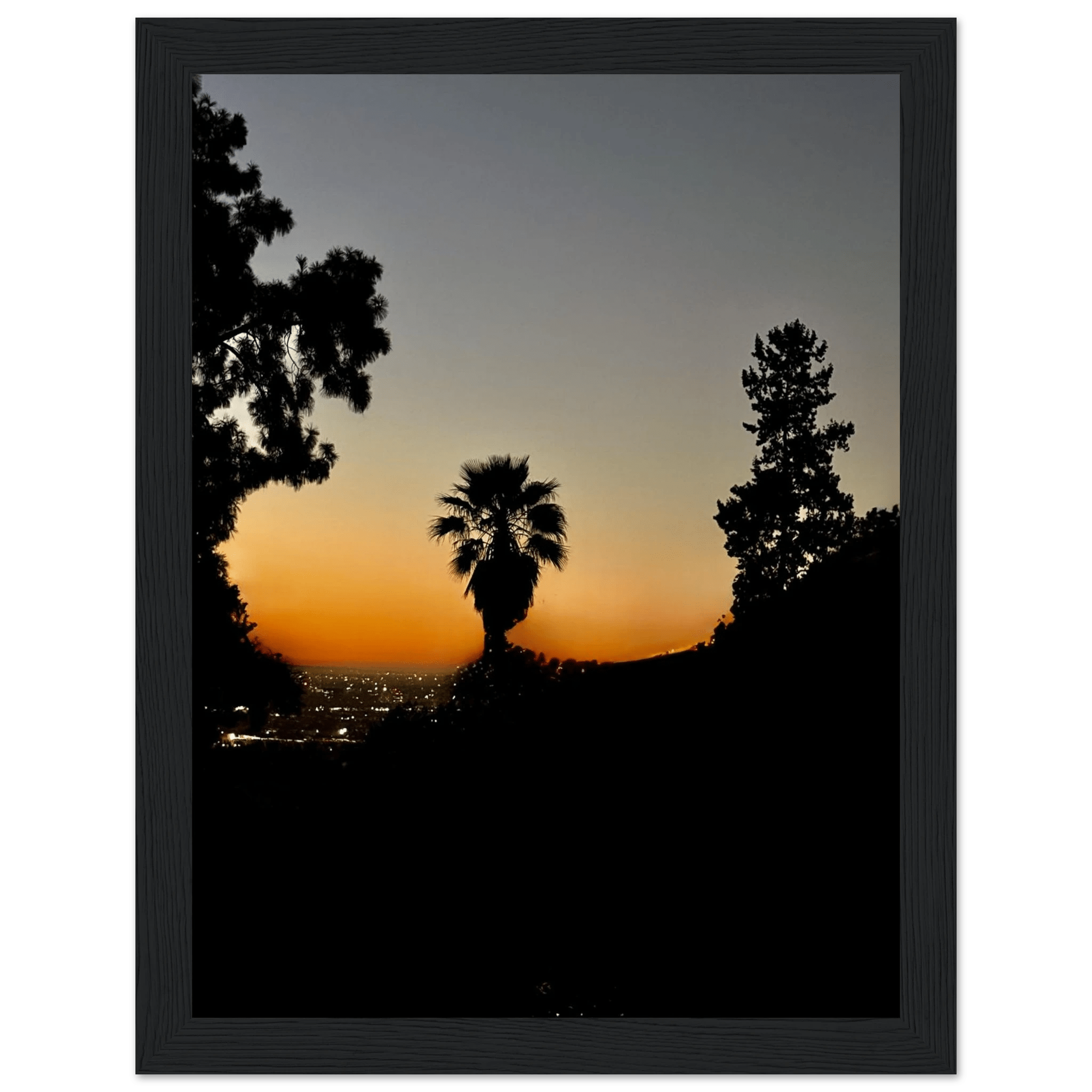 Framed print of a dramatic Hollywood Hills sunset poster with California vibes, featuring vibrant colors and scenic landscape artwork.