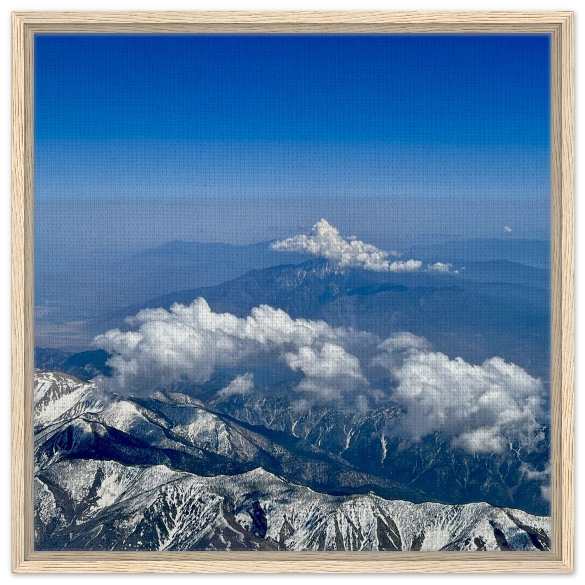 Framed canvas print of the Rocky Mountains showing blue skies and snow-covered peaks, part of the Travel Collection, Studio Edition.