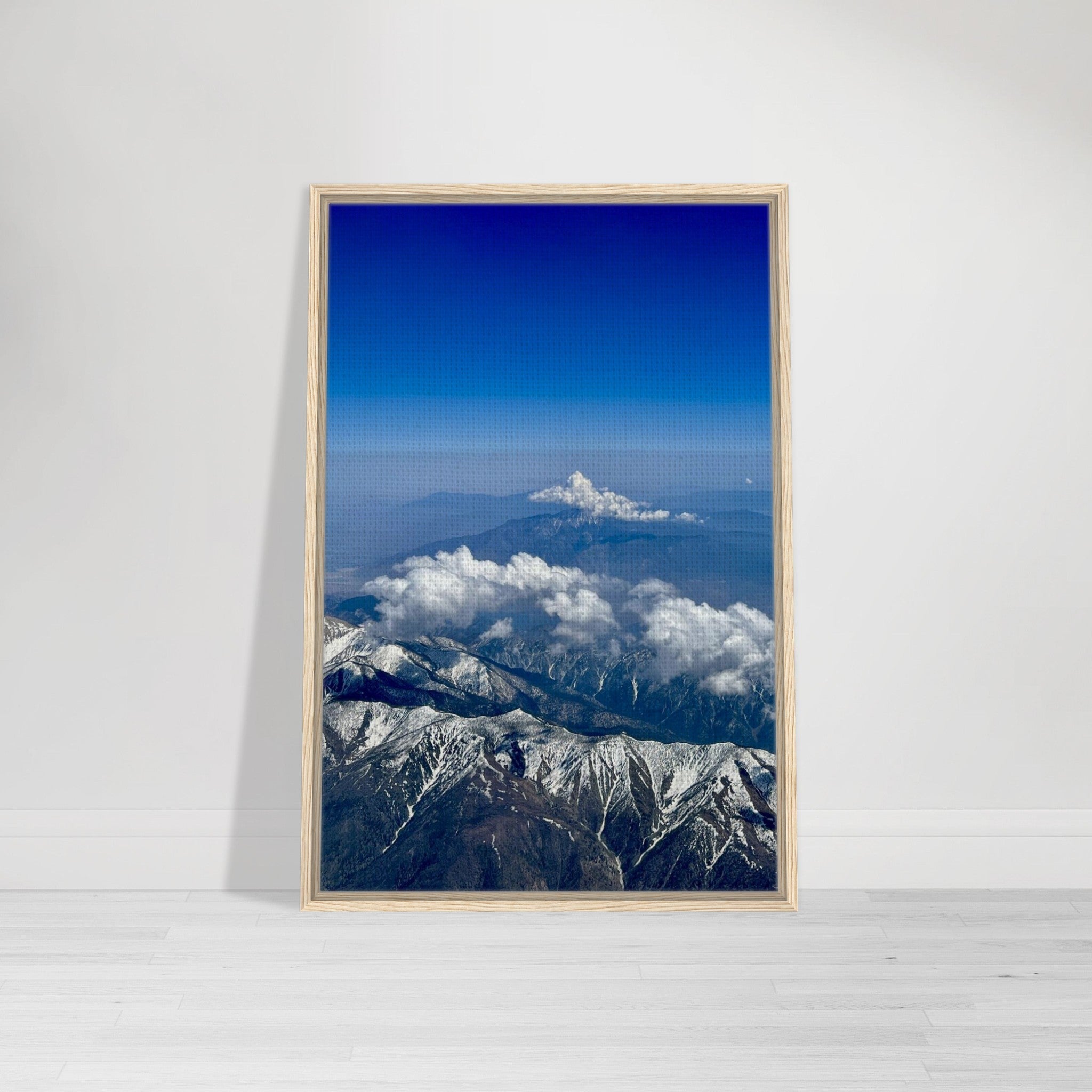 Framed canvas print of the Rocky Mountains with blue skies and snow-covered peaks, part of the Studio Edition travel collection.