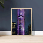 Framed canvas print of NYC holiday skyline in purple, showcasing iconic buildings in a stylish urban scene.