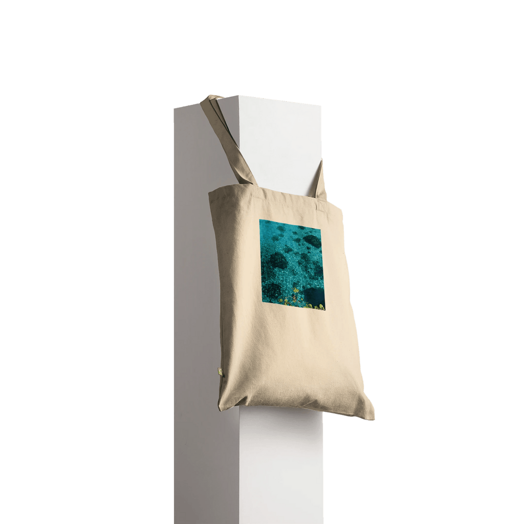 Eco-friendly cotton tote bag with long handles featuring a chic Caribbean Magic print, ideal for casual shopping and daily use.