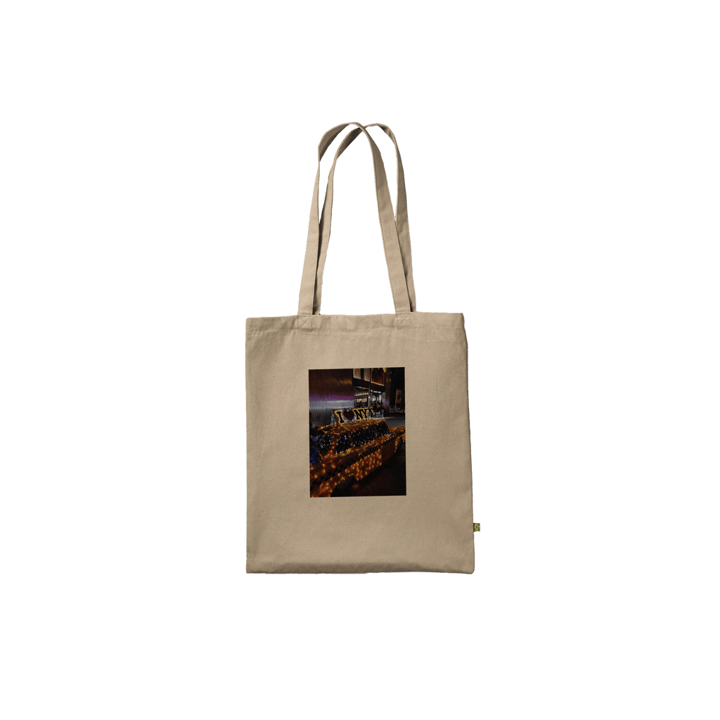 Eco-friendly cotton tote bag featuring a NYC taxi cab holiday magic print, stylish and durable for everyday use.