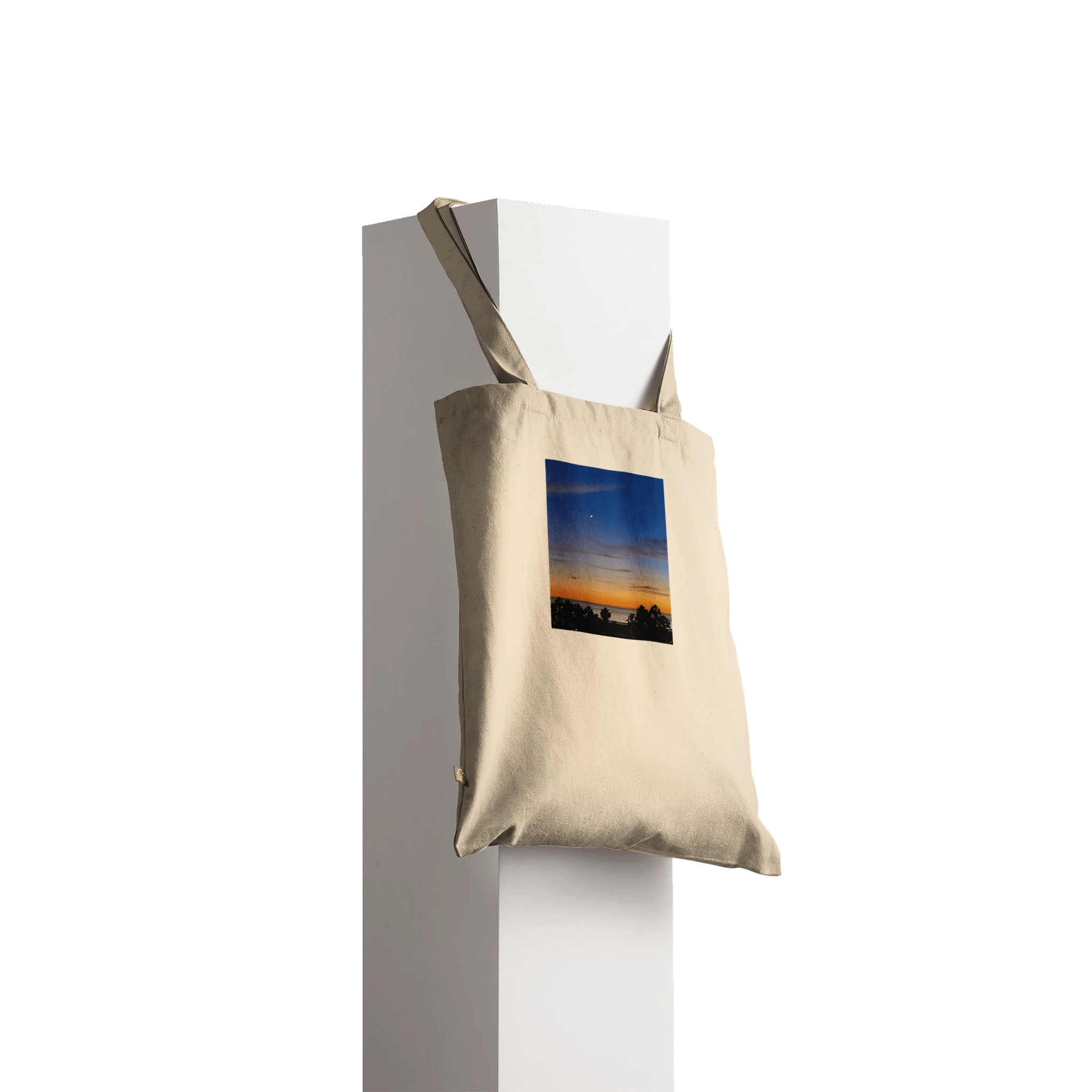 Eco-friendly California Sunset tote bag made of 100% cotton with vibrant sunset print, natural design showcasing colorful sky and silhouette.